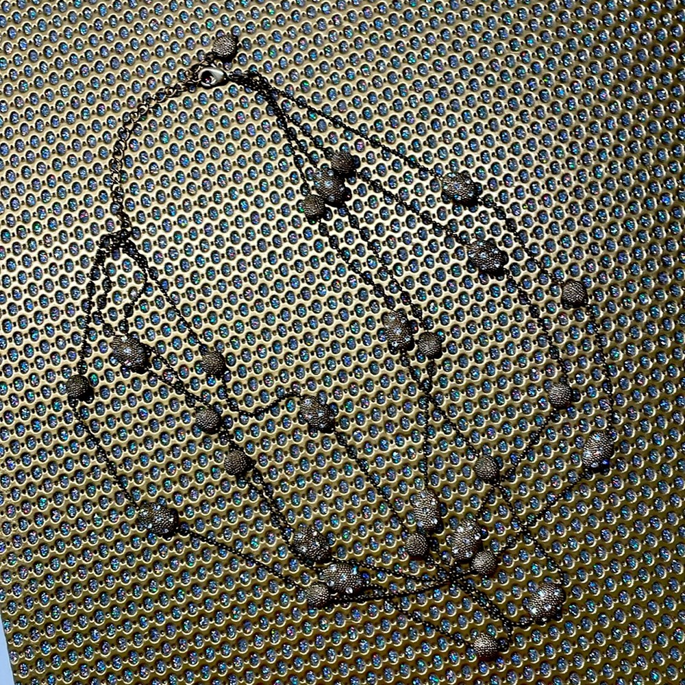 4 strands of circular and oval gold beads.